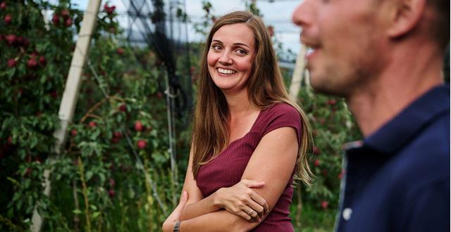 Apple farmer woman smiling at apple farmer in the orchard